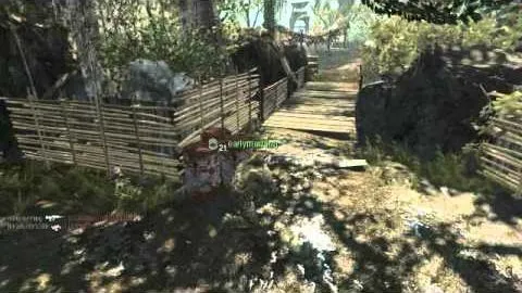 A jungle path with bamboo fencing and a wooden footbridge, a teammate tagged in green just ahead.