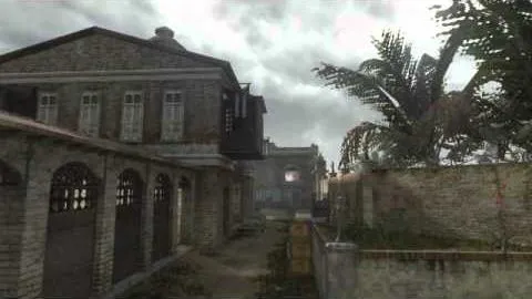 A deserted colonial street of shuttered stone buildings under a grey sky, palms hanging over the wall.